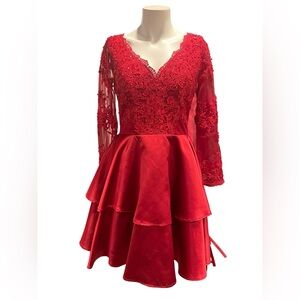 Red A-line dress with a tiered satin skirt and a V-neck lace bodice longsleeve.